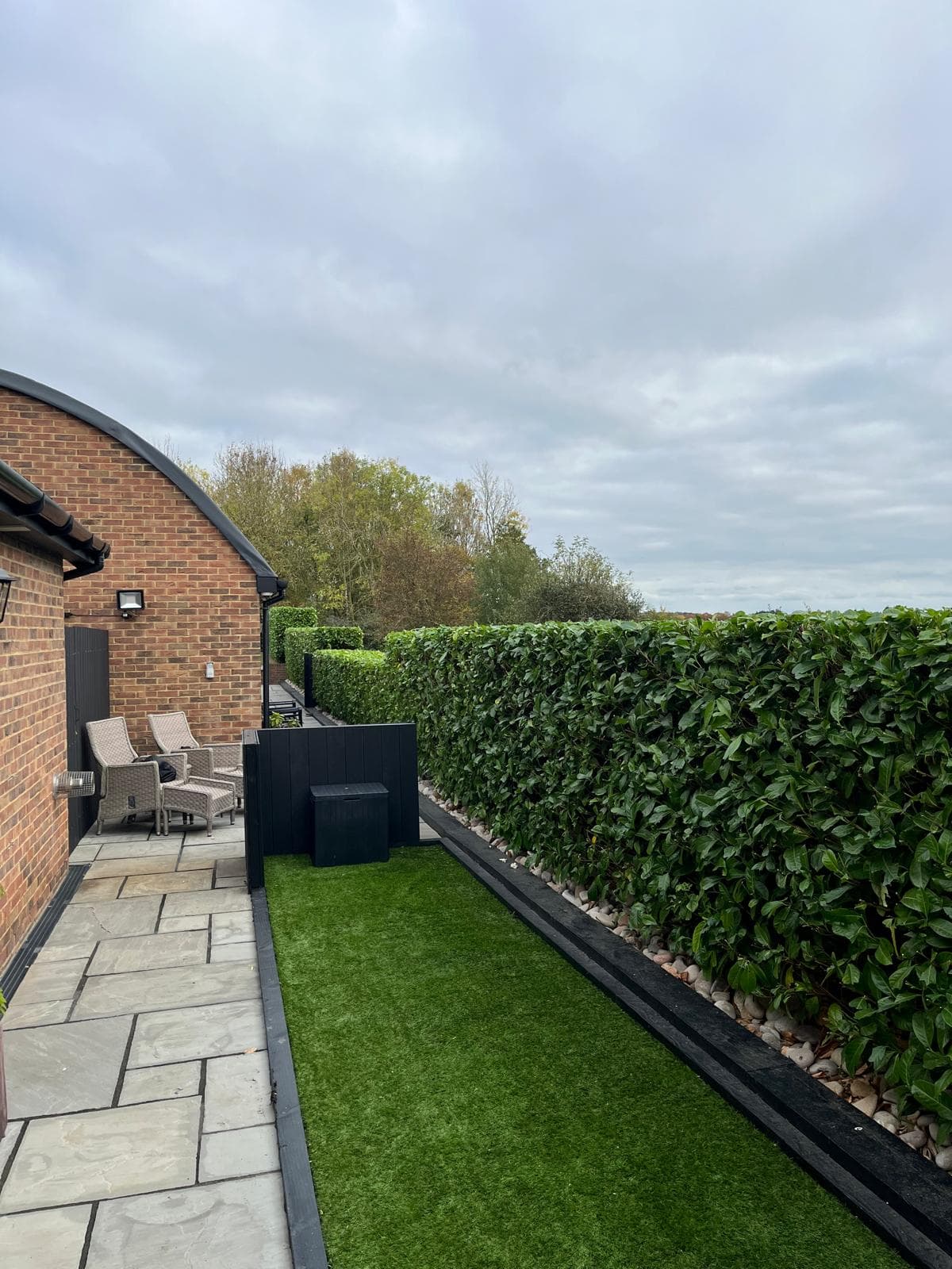 Modern patio with artificial lawn installation