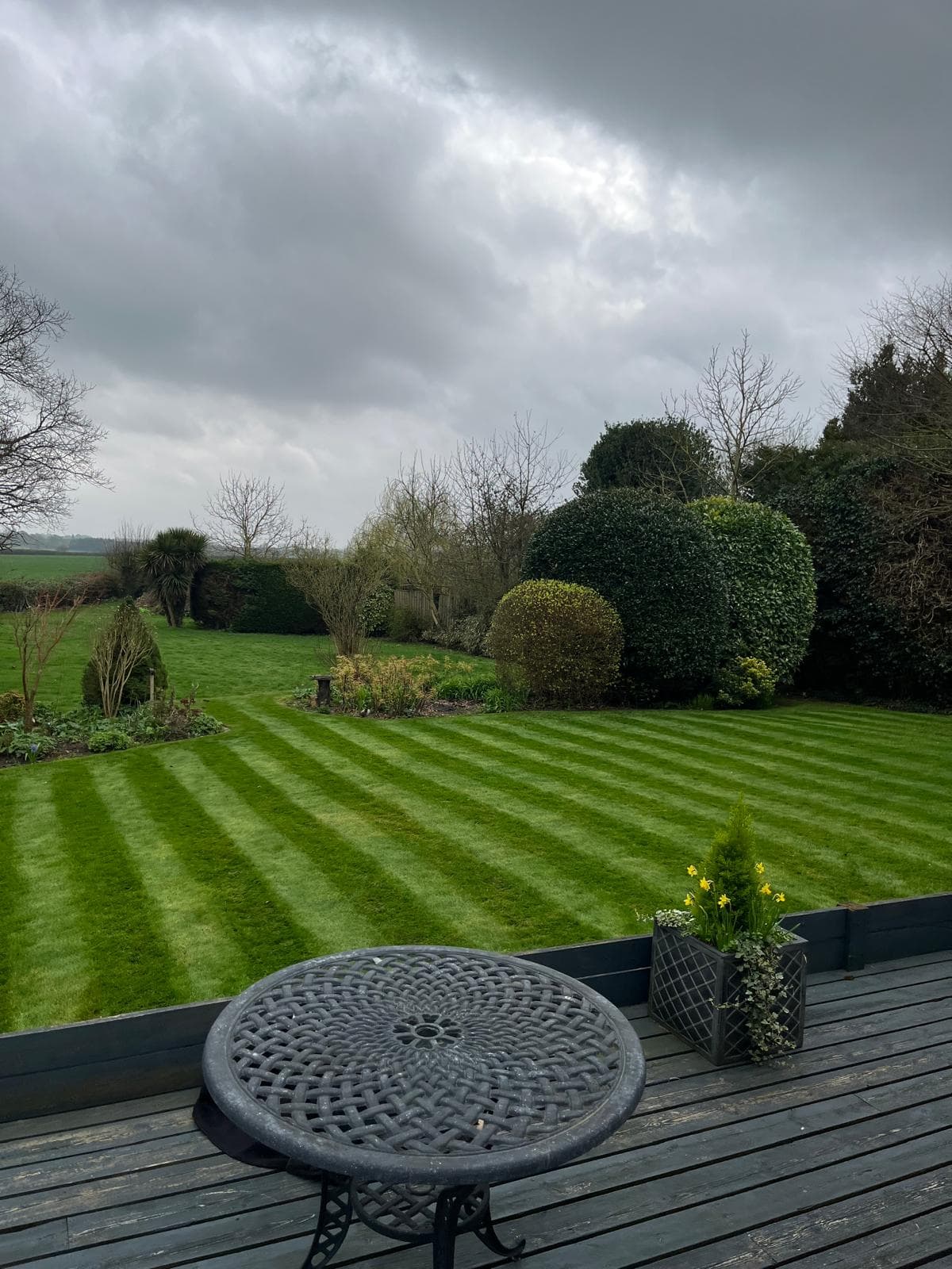 Striped lawn viewed from decking area